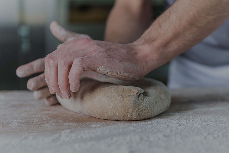 Two hands working a dough