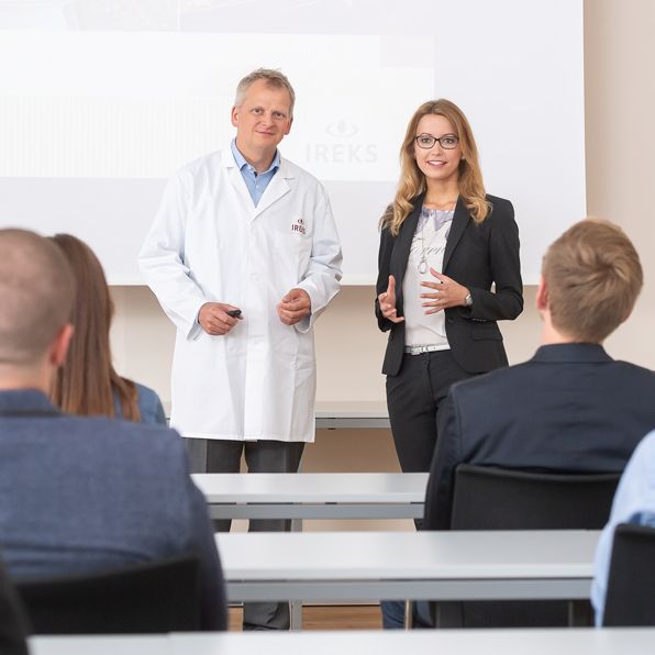 Two people giving a presentation to an audience